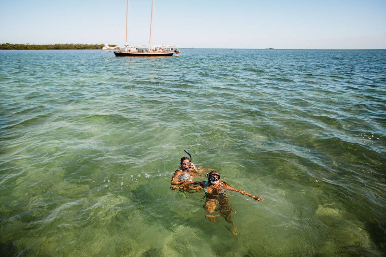 Two women in bikinis snorkeling in Key West