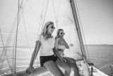 Two young women relax on a sailing charter in Key West with Danger Charters